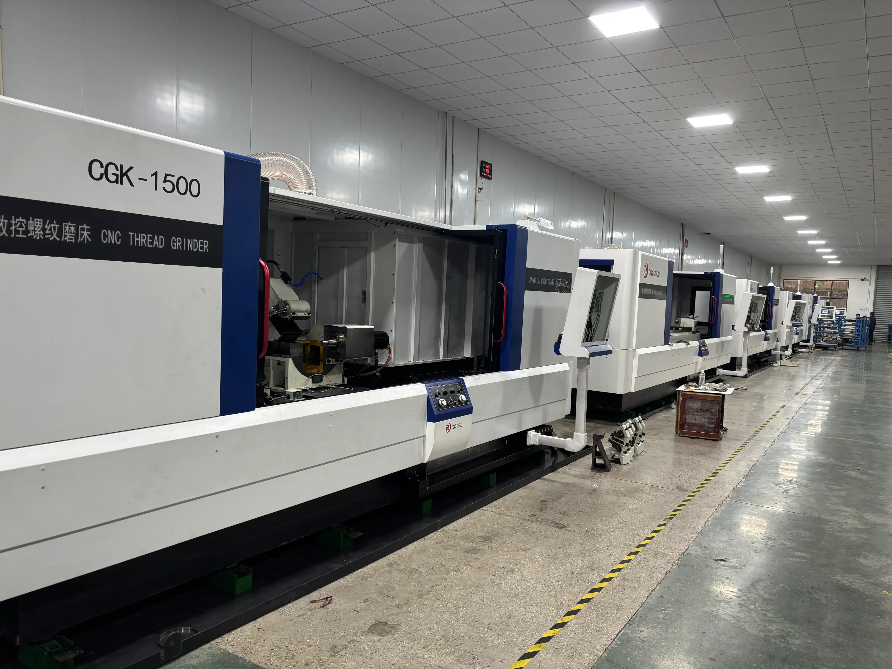 CGK-1500 CNC high-precision thread grinder finishing a long ball screw in a grinding shop